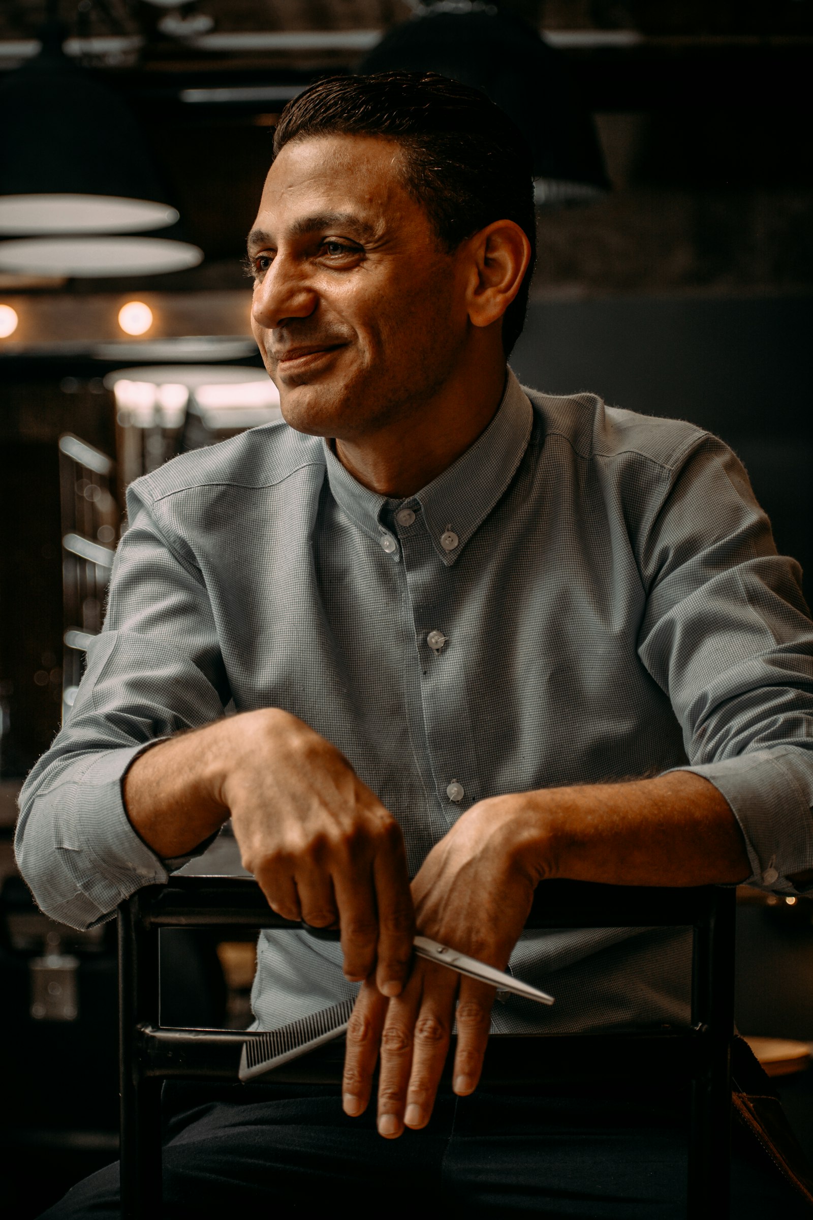 Smiling restaurant owner seated in his dining room